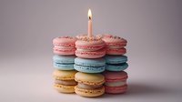Colorful macaron tower with birthday candle celebration dessert stack pink blue yellow treats on neutral background for party events.