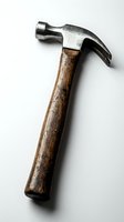 Vintage claw hammer with weathered wooden handle and metal head isolated on white background for construction and carpentry projects.
