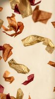 Colorful autumn leaves falling through air in warm golden light creating seasonal atmosphere for harvest decorations and fall themed projects.
