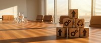 Wooden blocks with house and gear symbols stacked on office desk representing real estate development, business growth and property investment concepts.