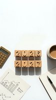 Wooden blocks displaying 2026 and 2027 years on white desk with calculator, coffee cup and business documents for planning and goal setting.