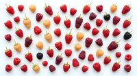Colorful assortment of fresh berries including strawberries, raspberries, blackberries and golden berries arranged on white background for healthy eating concepts.