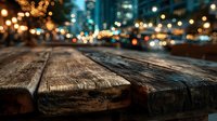 Rustic wooden table surface with blurred city lights and bokeh background at night creating warm atmospheric dining or product display space.