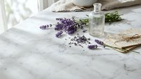 Fresh lavender flowers with glass bottle on marble surface near window creating peaceful aromatherapy spa atmosphere for relaxation and wellness.