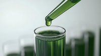 Green liquid dropping from pipette into laboratory glass test tube against blurred scientific background, medical research concept.