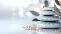 Zen balanced stone stack with warm bokeh lights creating peaceful spa atmosphere for meditation and wellness concepts.