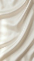 Luxurious cream silk fabric with flowing waves and soft folds creating elegant drapery texture for fashion and interior design projects.