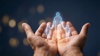 Young adult male hands holding glowing holographic family figures against dark bokeh background. Concept for family protection, insurance, care, support services, and community welfare programs.