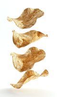 Golden metallic leaf shapes floating on white background, abstract luxury design elements isolated for creative projects and premium packaging decoration.