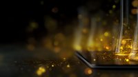 Glowing laboratory glassware with golden liquid and magical sparkles on dark background creates mystical scientific atmosphere for research concepts.
