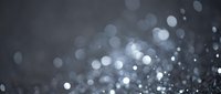 Abstract blurred bokeh lights background with soft glowing circles and sparkles creating dreamy atmosphere for design projects and presentations.