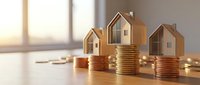 Miniature wooden houses standing on stacked coins with warm sunlight streaming through window, representing real estate investment, property value growth, and financial planning for homeownership.