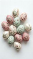 Pastel Easter eggs with delicate botanical leaf patterns in soft pink, mint green and cream colors arranged on white background for spring holiday decoration.