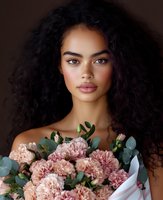Young African American woman with curly hair holding pink chrysanthemum bouquet against dark background for beauty and lifestyle concepts.