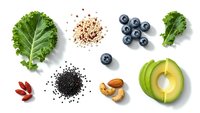 Healthy superfood ingredients flat lay with kale, avocado, blueberries, chia seeds, quinoa and nuts on white background for clean eating recipes.