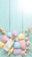Pastel seashells and glass bottle arranged on weathered mint green wooden planks with dried flowers for coastal spa and summer vacation themes.