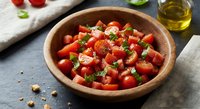 Fresh tomato salad with herbs and olive oil in wooden bowl on rustic table, healthy Mediterranean cuisine for summer dining and cooking recipes.