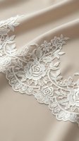 Delicate white lace trim with rose and leaf embroidery on cream fabric, ideal for wedding gowns, bridal accessories, and formal garment embellishment.