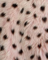 Pink fluffy fur texture with black spots pattern, seamless background for fashion and textile design, luxurious animal print surface.