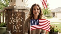 Smiling young Caucasian woman holding American flag celebrating Labor Day holiday outdoors with patriotic decorations and wooden sign in residential setting.