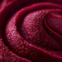 Macro shot of dark red berry sorbet swirl with frosty crystalline texture showing smooth frozen dessert curves and creamy gelato details.