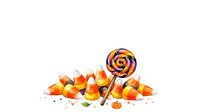 Isolated pile of candy corn with orange, yellow and white striped lollipop on white background, ready for design use on packaging, invitations, and seasonal marketing materials.