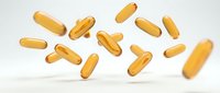 Golden omega-3 fish oil capsules floating in air on white background, dietary supplements for health and wellness nutrition.