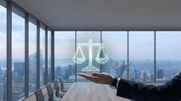 Lawyer holding scales of justice icon above hand in modern office with city skyline view, representing legal services, law firm, attorney consultation, and professional justice concept.