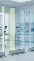 Futuristic glowing glass panels with yellow and blue neon light strips displayed in a modern white laboratory with microscopes.
