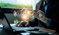 Professional businessman using laptop with glowing energy efficiency icons representing smart home technology and sustainable solutions for modern living.