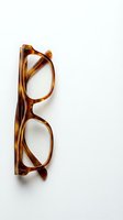 Stylish tortoiseshell eyeglasses with amber brown frames isolated on white background for optical shop advertising and fashion accessories design.