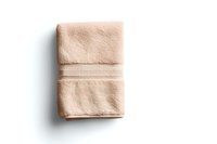 Folded beige cotton bath towel with decorative stripes isolated on white background, soft texture visible. Ready for spa, bathroom interior and hotel amenities.