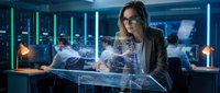 Professional businesswoman analyzing holographic data visualization in modern tech office environment for corporate presentations.