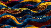 Vibrant wavy pattern with dotted lines in yellow, red, blue and orange creates dynamic abstract background with tribal aboriginal art style influence. Macro view.