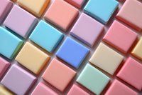 Colorful soap bars arranged in diagonal pattern creating modern geometric composition with pastel pink, blue, purple and beige tones on light background.
