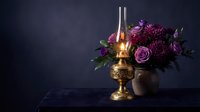 Vintage brass oil lamp glowing beside elegant purple flower arrangement with roses and dahlias on dark moody background for romantic decor.