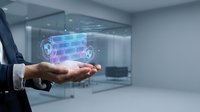 Businessman holding digital holographic truck model with glowing blue and pink grid network in modern office space for logistics and transportation technology concepts.