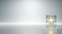 Glass cup with glowing light bulb inside on white background, isolated for design use on product packaging, web graphics, and marketing materials.
