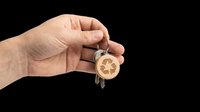 Caucasian hand holding wooden car-shaped keychain with keys attached, isolated on transparent background. Ready for design use on t-shirts, clipart, stickers, print-on-demand products, and sublimation projects.