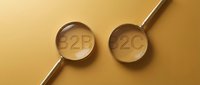 Two magnifying glasses with B2B and B2C text on golden background, representing business models and market segments for corporate strategy.