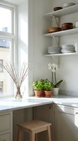 Minimalist kitchen corner with floating shelves displaying dishes and wooden bowls, marble countertop, potted plants and natural light from window.