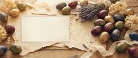 Autumn harvest composition with blank card, colorful acorns, pine cones and burlap on rustic wooden background for seasonal greeting designs.