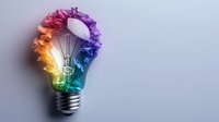 Colorful rainbow smoke forming light bulb shape with filament on gray background, symbolizing creative innovation and bright ideas.