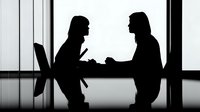 Two business professionals in silhouette having meeting discussion at modern office table with laptop, corporate teamwork and collaboration concept.