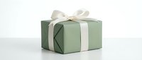 Green gift box with white satin ribbon bow on clean white background, isolated for holiday design projects and festive marketing materials.