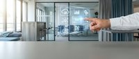 Professional businessman pointing at holographic digital interface with cloud computing and data analytics icons in modern office environment.