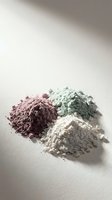 Natural cosmetic clay powder piles in purple, green and white colors for skincare face masks and spa treatments on neutral background.