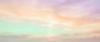 Soft pastel sky with dreamy clouds in pink, purple, yellow and mint green hues creating ethereal atmosphere for backgrounds and design projects.
