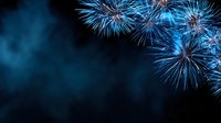 Spectacular blue fireworks exploding against dark night sky, creating festive atmosphere for celebration events and holiday backgrounds.
