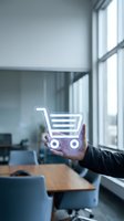 Person holding neon shopping cart icon in modern office with large windows, representing e-commerce, retail technology, and digital commerce solutions for business applications.